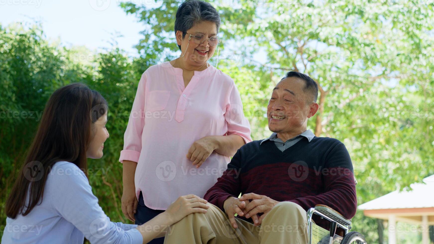A daughter taking care of the patient in a wheelchair and talk with mom. Concept of happy retirement with care from a caregiver and Savings and senior health insurance, Happy family and retirement photo