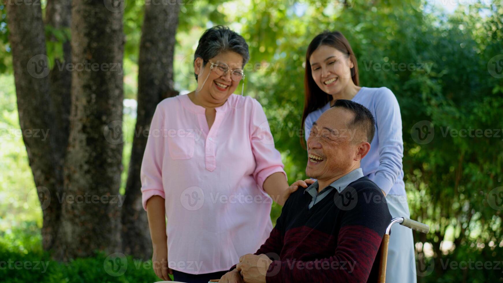 A daughter taking care of the patient in a wheelchair and talk with mom. Concept of happy retirement with care from a caregiver and Savings and senior health insurance, Happy family and retirement photo