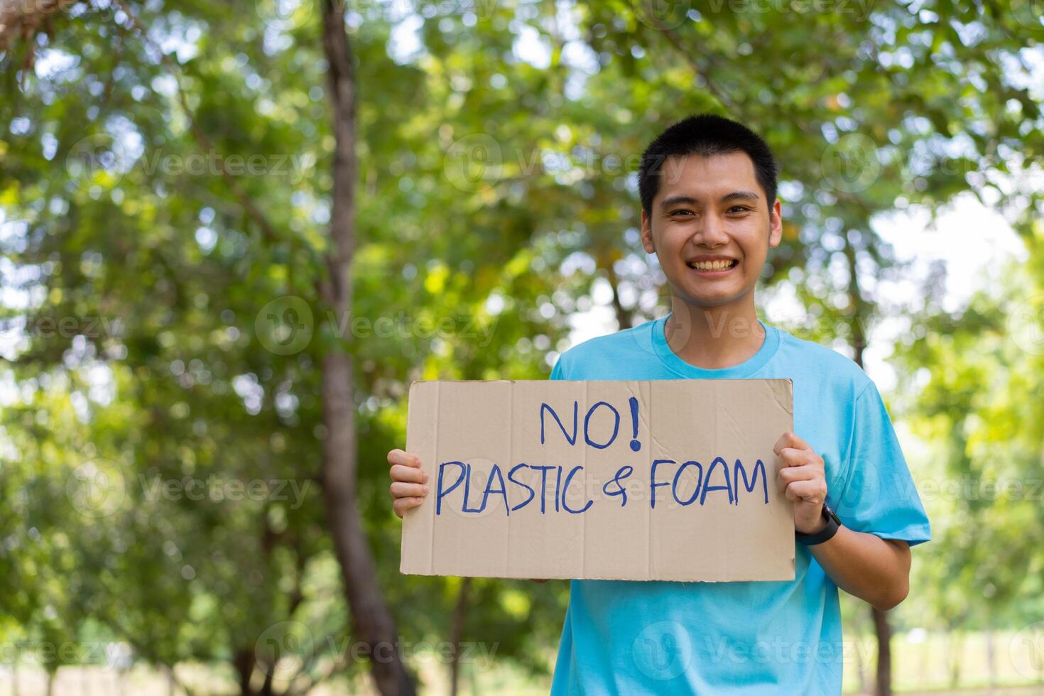 Happy young Asian students diverse volunteers hold a campaign sign for cleaning in the park, The concept of environmental conservation on world environment day, recycling, charity for sustainability. photo