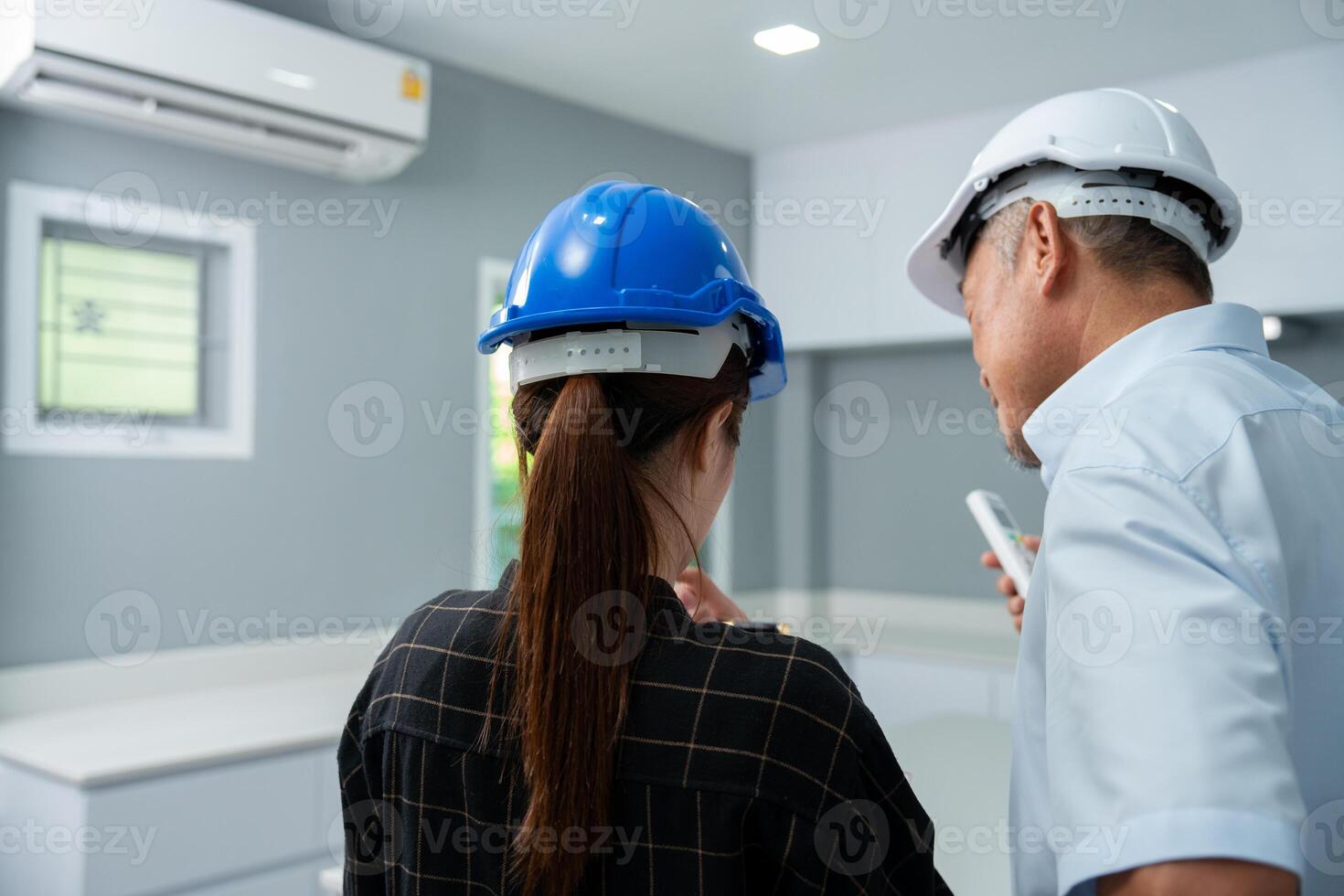 Senior home inspector checking home defects and teaching young engineers, before handing it over to client. Young engineers learn home inspection with Senior, Real estate, and renovation concepts. photo