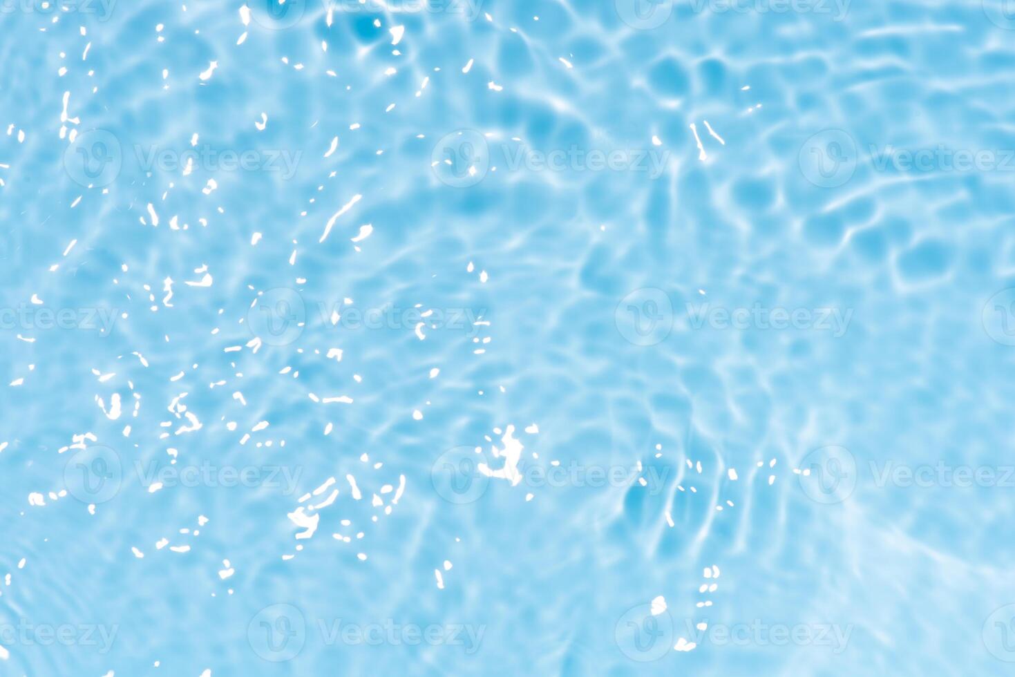 Bluewater waves on the surface ripples blurred. Defocus blurred transparent blue colored clear calm water surface texture with splash and bubbles. Water waves with shining pattern texture background. photo
