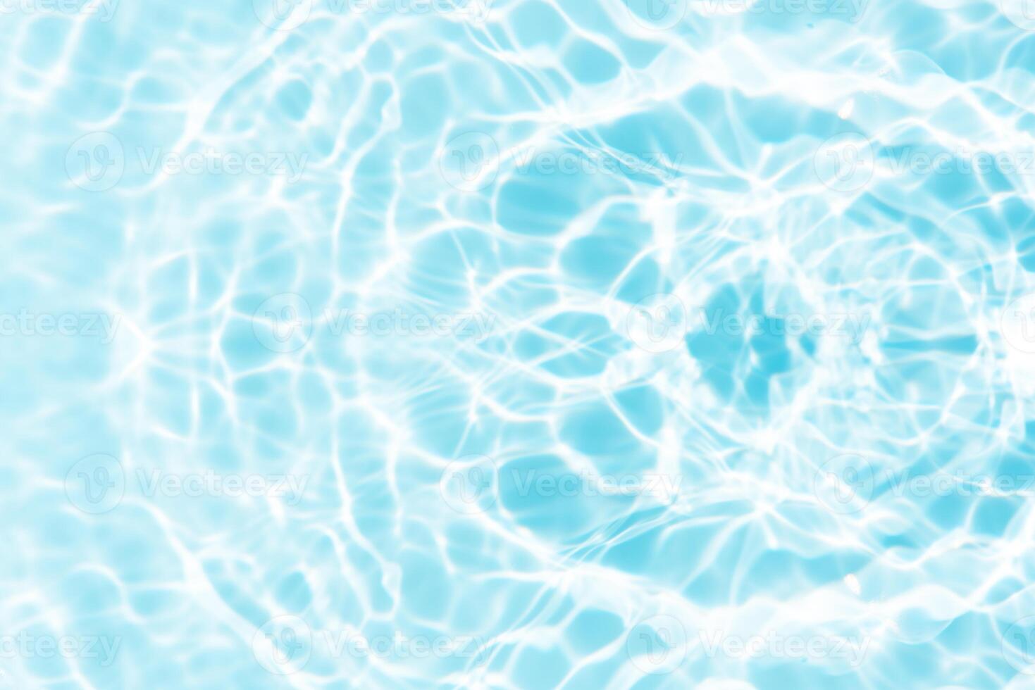 Water surface. Bluewater waves on the surface ripples blurred. Defocus blurred transparent blue colored clear calm water surface texture with splash and bubbles. Water waves with shining pattern. photo