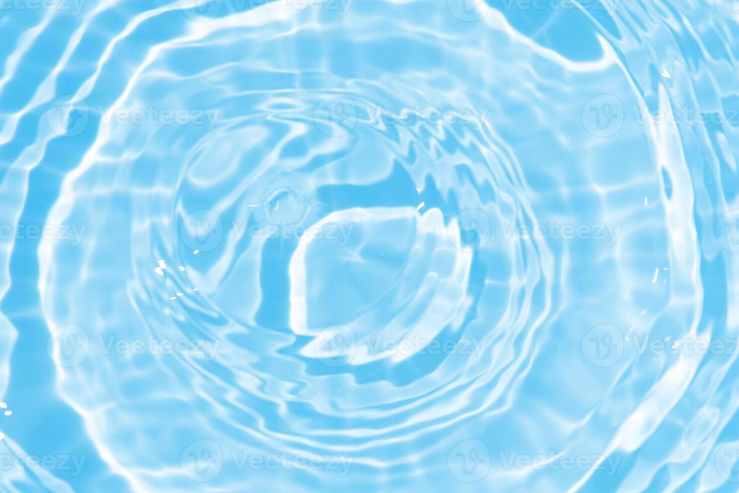 Water surface. Bluewater waves on the surface ripples blurred. Defocus blurred transparent blue colored clear calm water surface texture with splash and bubbles. Water waves with shining pattern. photo