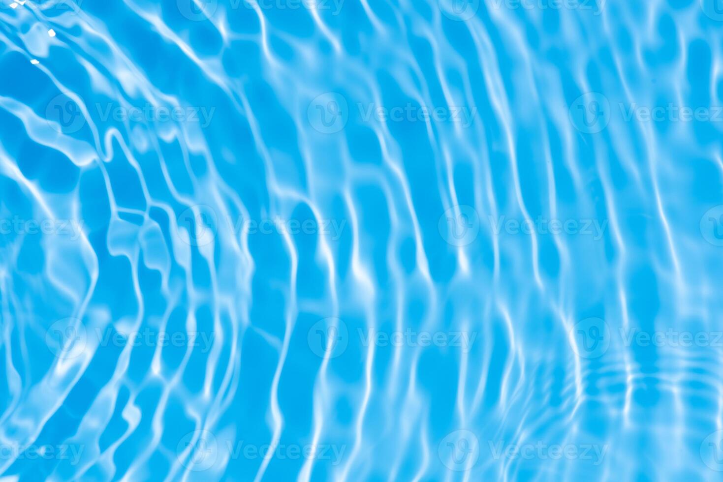 Water surface. Bluewater waves on the surface ripples blurred. Defocus blurred transparent blue colored clear calm water surface texture with splash and bubbles. Water waves with shining pattern. photo