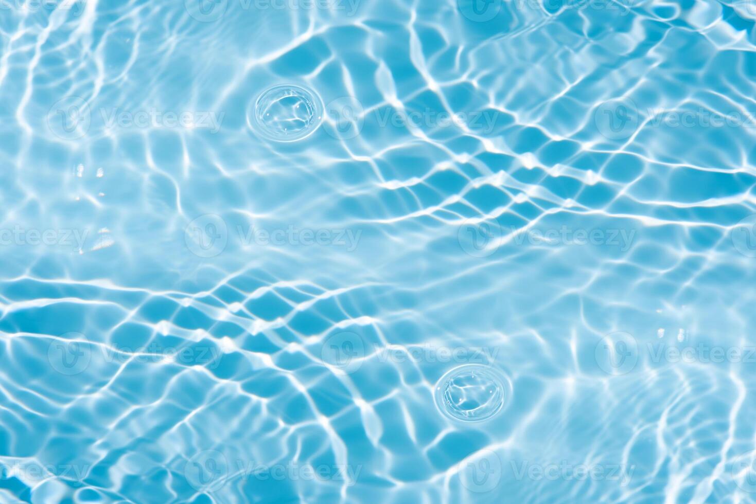 Bluewater waves on the surface ripples blurred. Defocus blurred transparent blue colored clear calm water surface texture with splash and bubbles. Water waves with shining pattern texture background. photo