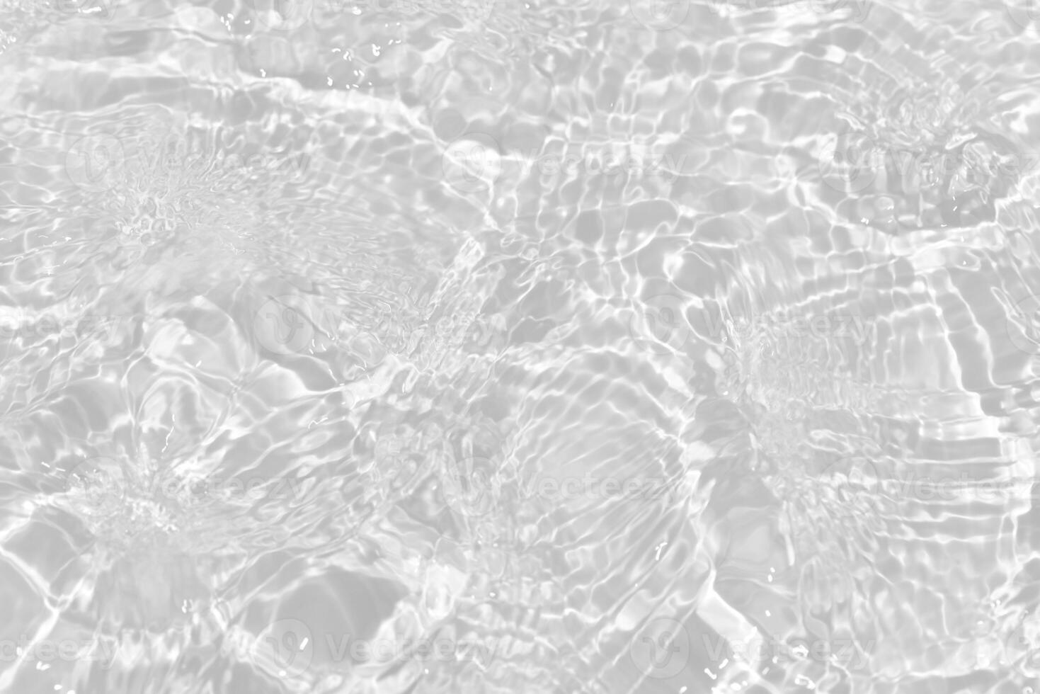 Bluewater waves on the surface ripples blurred. Defocus blurred transparent blue colored clear calm water surface texture with splash and bubbles. Water waves with shining pattern texture background. photo