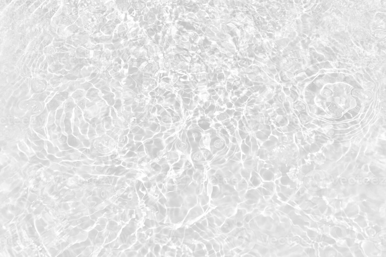 Bluewater waves on the surface ripples blurred. Defocus blurred transparent blue colored clear calm water surface texture with splash and bubbles. Water waves with shining pattern texture background. photo