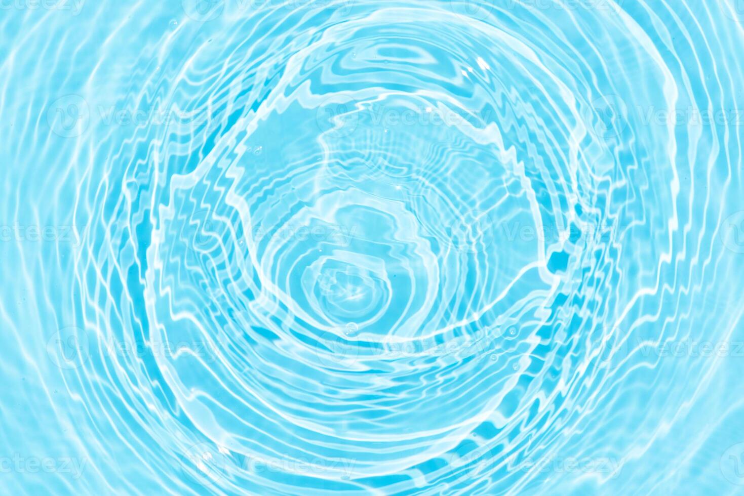 Bluewater waves on the surface ripples blurred. Defocus blurred transparent blue colored clear calm water surface texture with splash and bubbles. Water waves with shining pattern texture background. photo