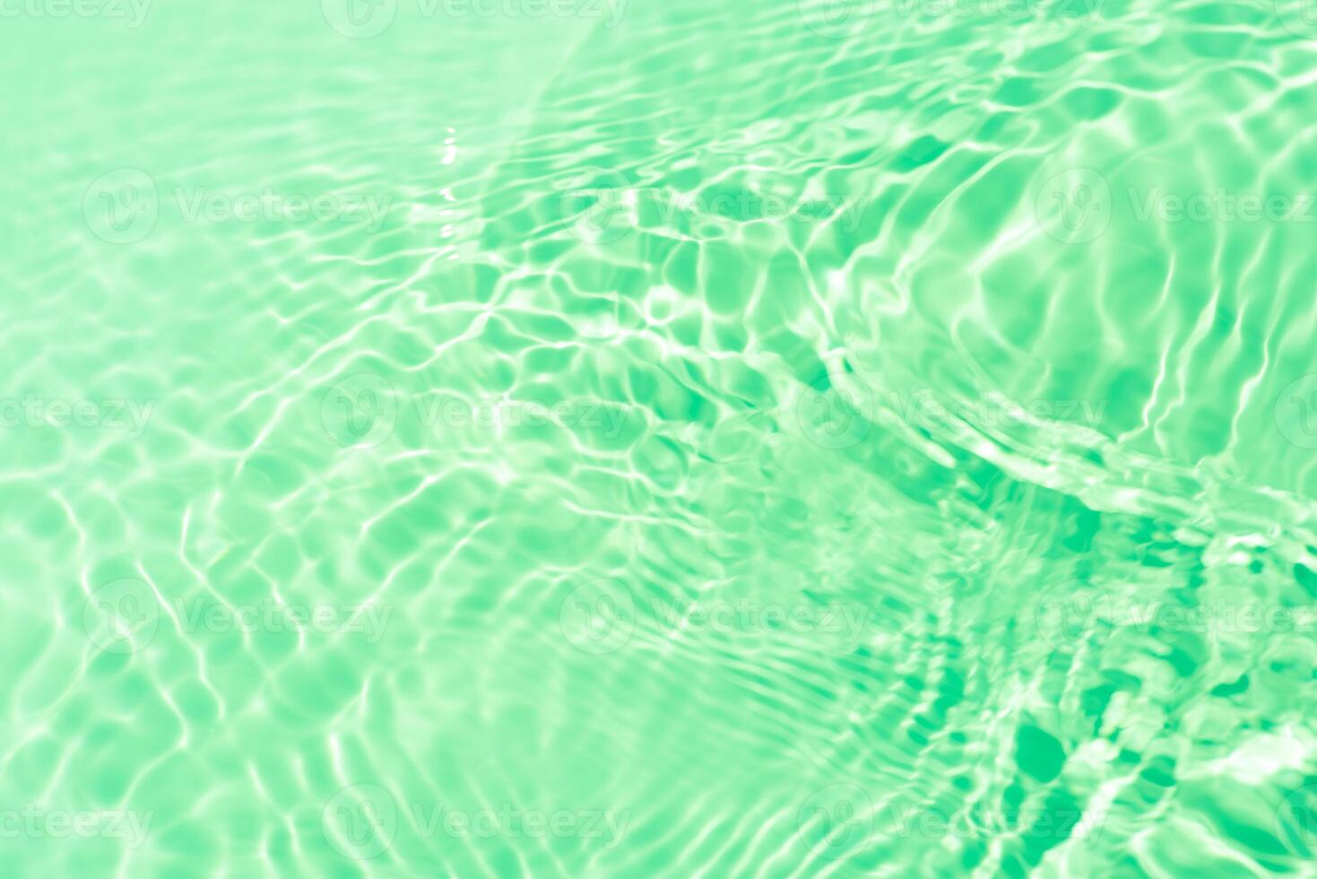 Water surface. Bluewater waves on the surface ripples blurred. Defocus blurred transparent blue colored clear calm water surface texture with splash and bubbles. Water waves with shining pattern. photo