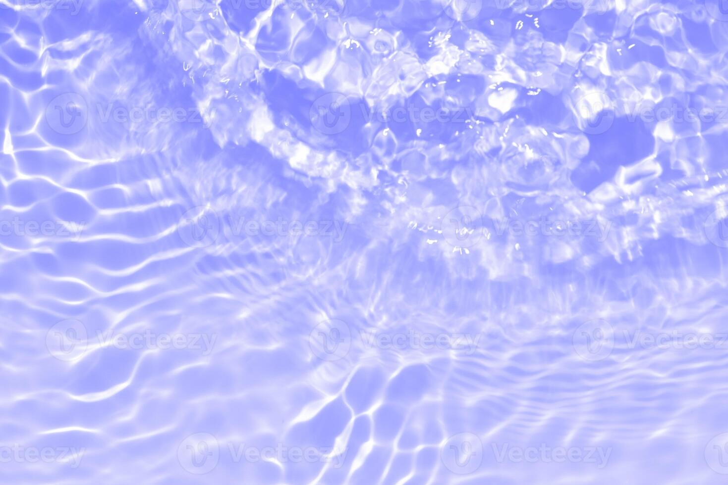 Water surface. Bluewater waves on the surface ripples blurred. Defocus blurred transparent blue colored clear calm water surface texture with splash and bubbles. Water waves with shining pattern. photo