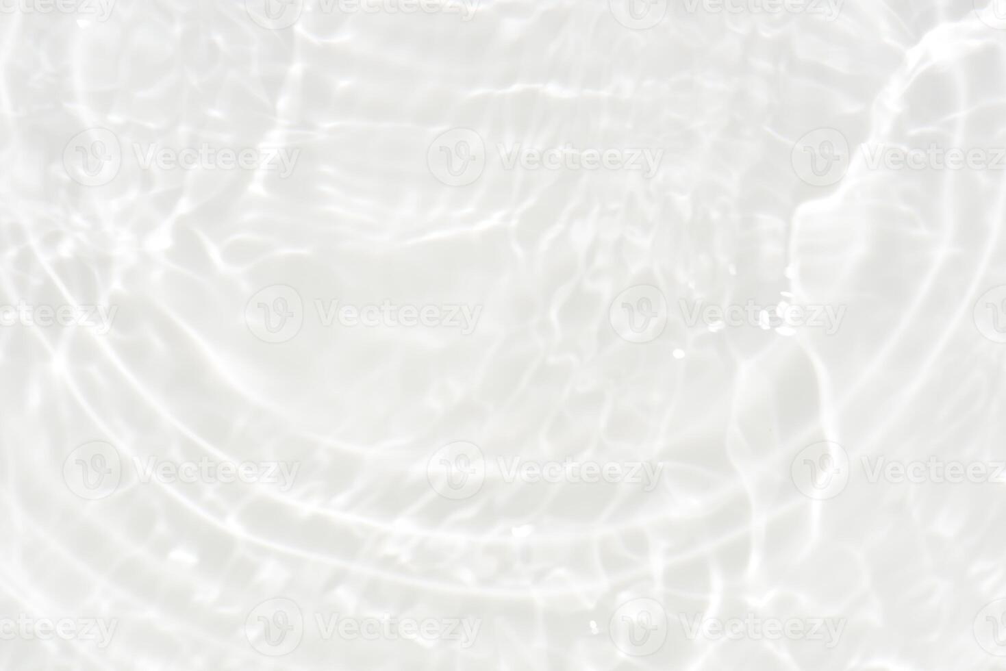 White water with ripples on the surface. Defocus blurred transparent white colored clear calm water surface texture with splashes and bubbles. Water waves with shining pattern texture background. photo