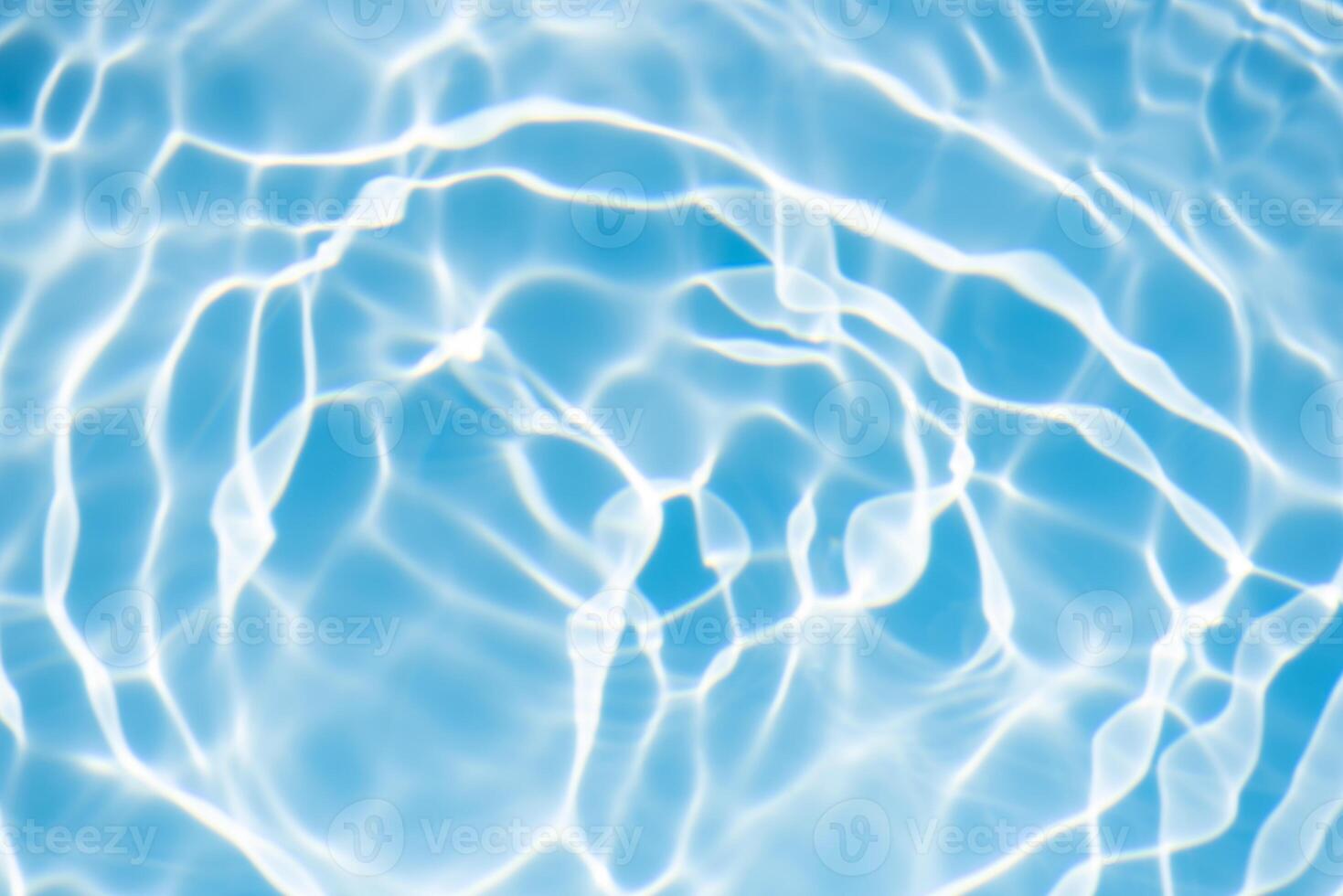 Bluewater waves on the surface ripples blurred. Defocus blurred transparent blue colored clear calm water surface texture with splash and bubbles. Water waves with shining pattern texture background. photo