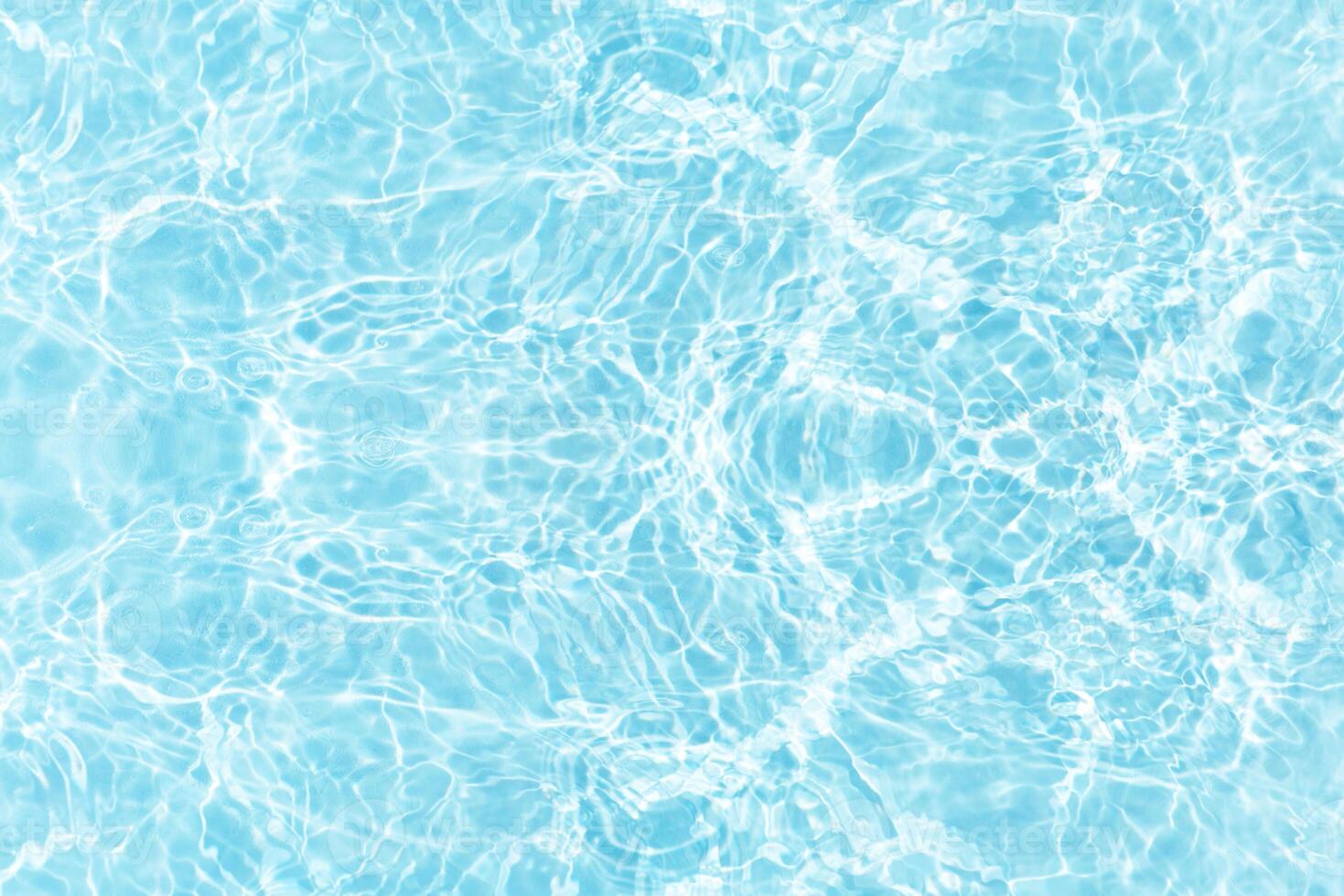 Water surface. Bluewater waves on the surface ripples blurred. Defocus blurred transparent blue colored clear calm water surface texture with splash and bubbles. Water waves with shining pattern. photo