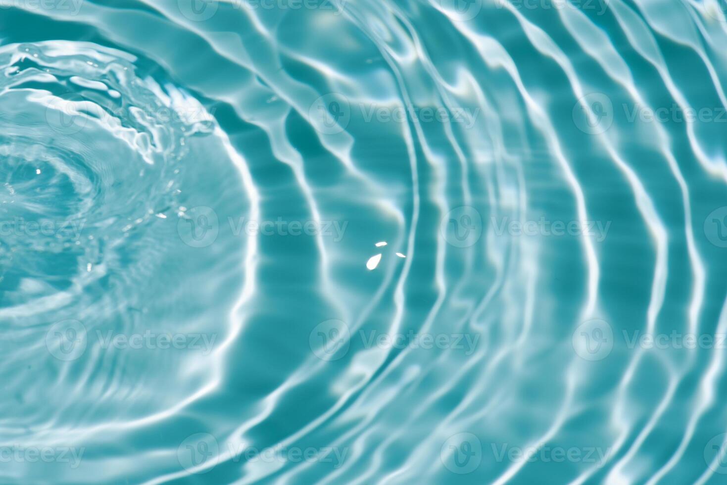 Water surface. Bluewater waves on the surface ripples blurred. Defocus blurred transparent blue colored clear calm water surface texture with splash and bubbles. Water waves with shining pattern. photo