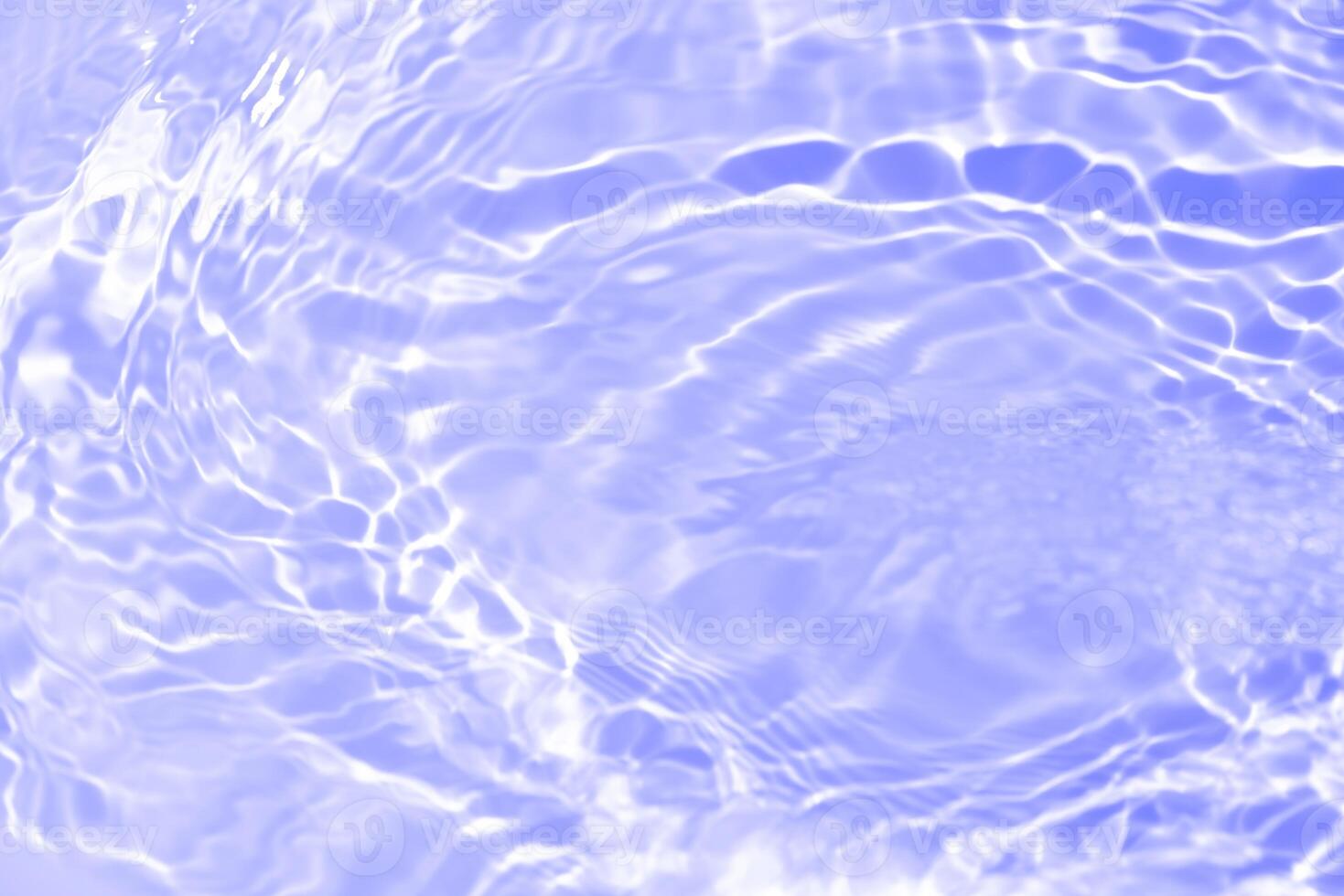 Water surface. Bluewater waves on the surface ripples blurred. Defocus blurred transparent blue colored clear calm water surface texture with splash and bubbles. Water waves with shining pattern. photo