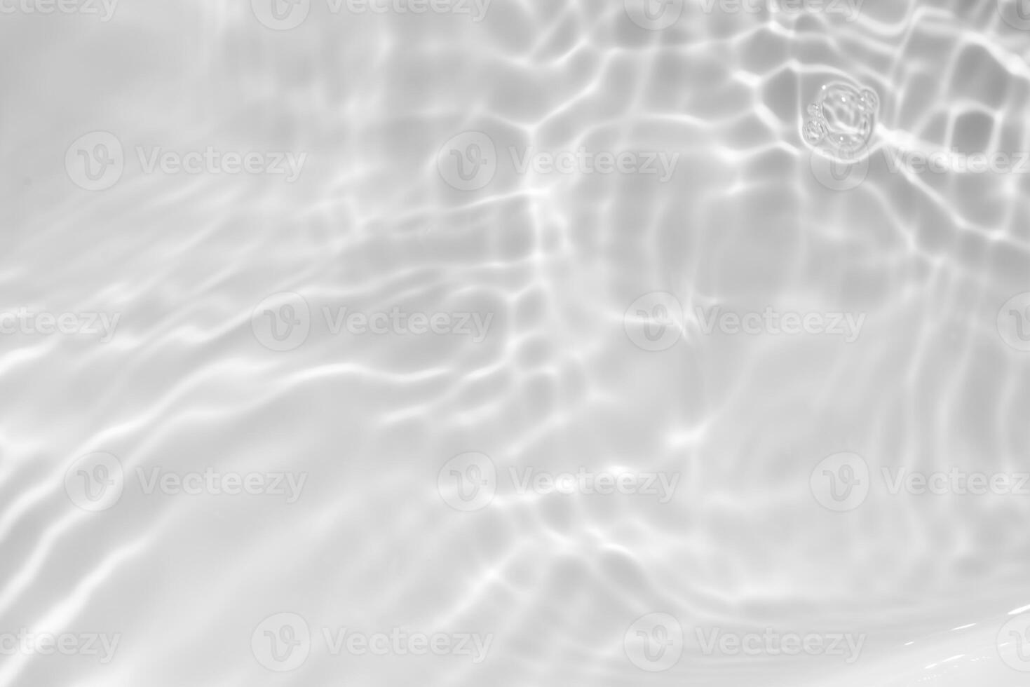 Water surface. Bluewater waves on the surface ripples blurred. Defocus blurred transparent blue colored clear calm water surface texture with splash and bubbles. Water waves with shining pattern. photo