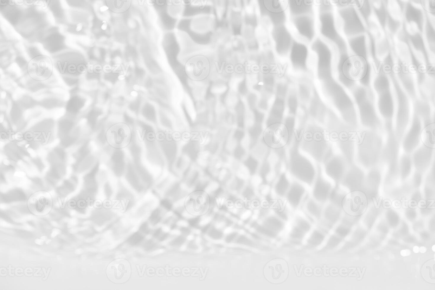 Bluewater waves on the surface ripples blurred. Defocus blurred transparent blue colored clear calm water surface texture with splash and bubbles. Water waves with shining pattern texture background. photo