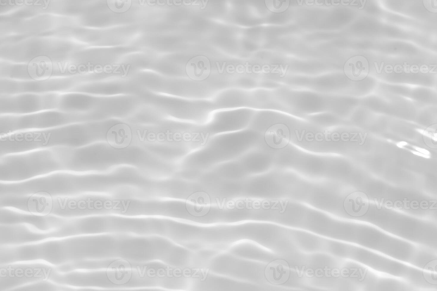 Bluewater waves on the surface ripples blurred. Defocus blurred transparent blue colored clear calm water surface texture with splash and bubbles. Water waves with shining pattern texture background. photo