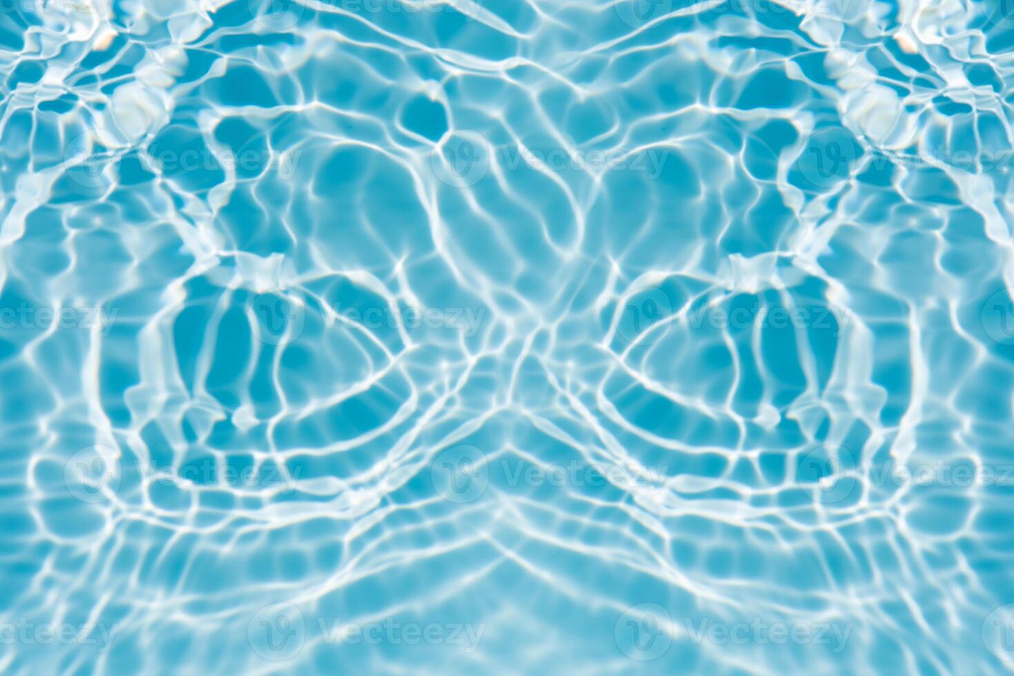 Water surface. Bluewater waves on the surface ripples blurred. Defocus blurred transparent blue colored clear calm water surface texture with splash and bubbles. Water waves with shining pattern. photo