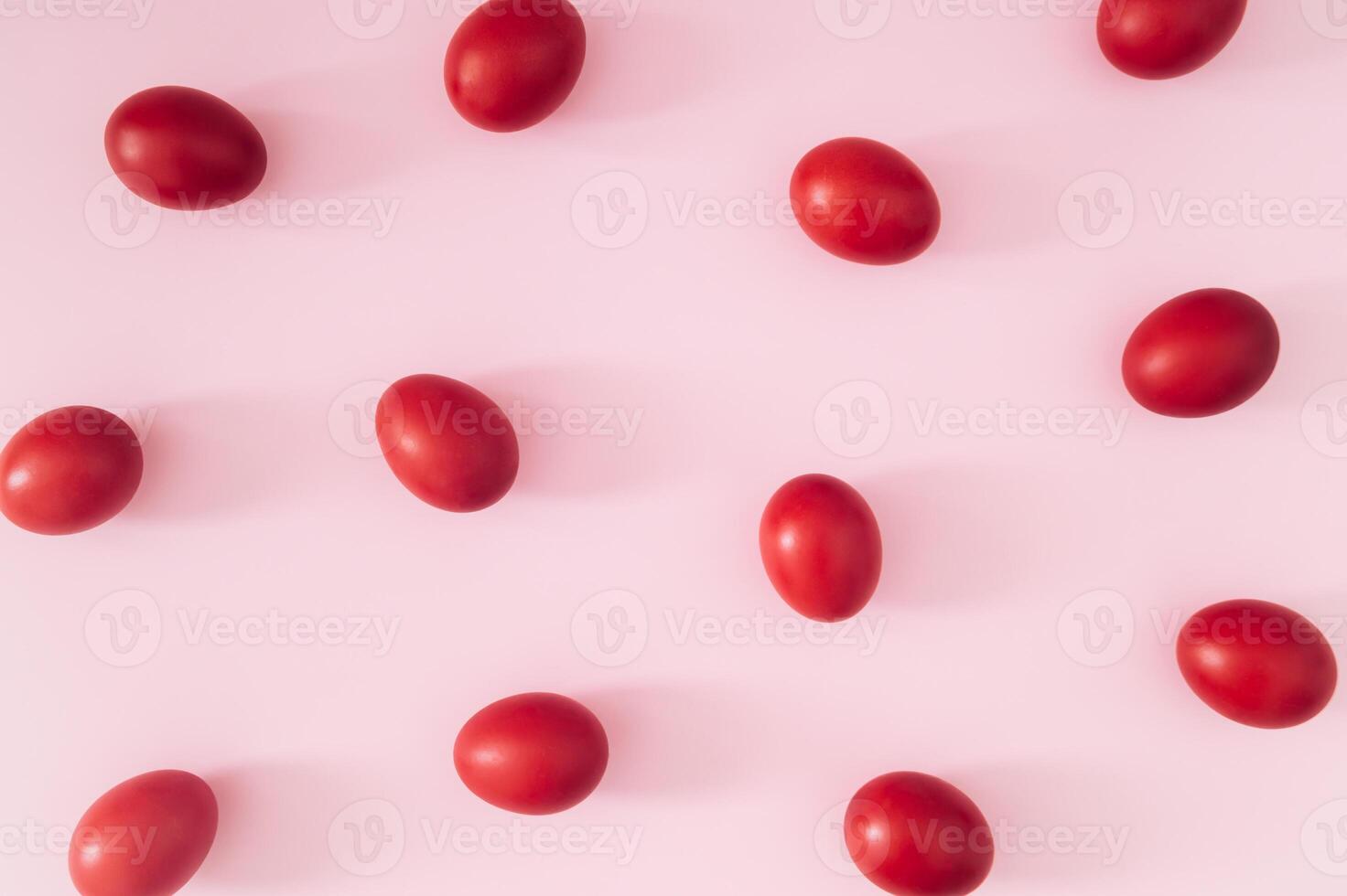 Creative Easter pattern composition made with red colored Easter eggs on light pink background. Minimal Easter concept. Spring holiday pattern background. Flay lay, top of view. photo