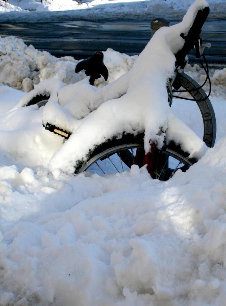 Bike covered in snow on a cold winter day photo