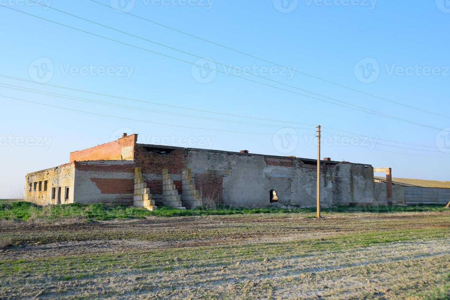 Old soviet brick abandoned building. Collapsing brick construction. photo