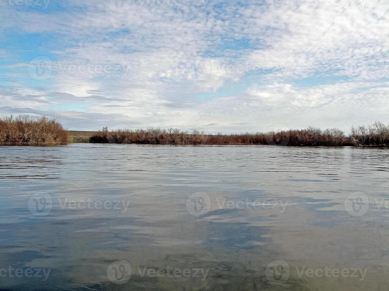 River landscape Early spring. bare trees, melting snow. photo