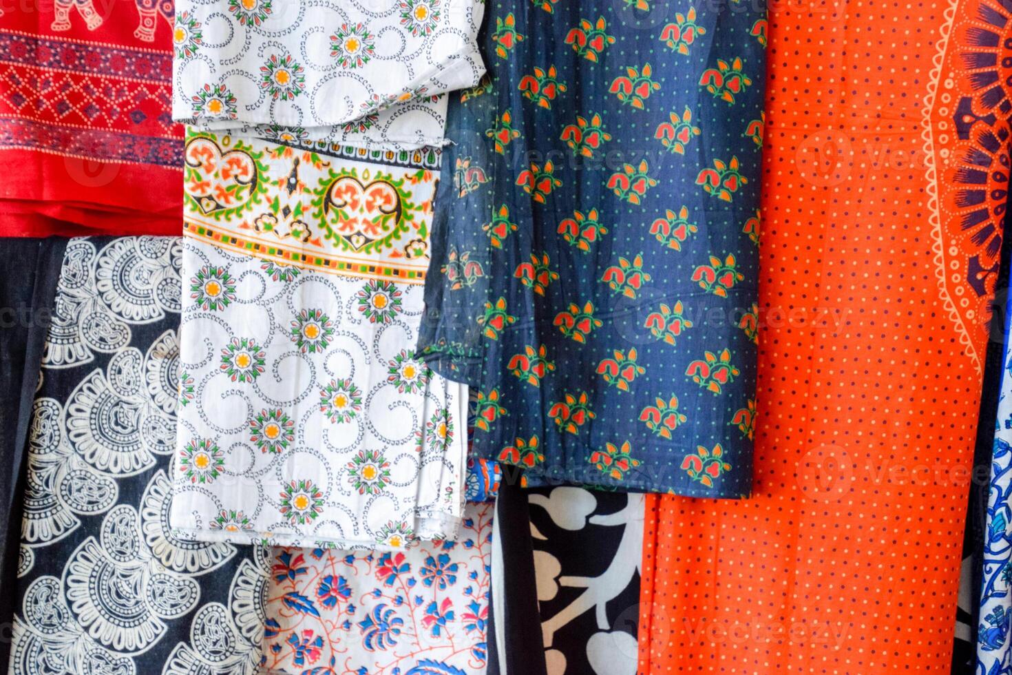 Indian fabrics hanging on the counter. Trade in fabrics from india. Fabric with patterns and patterns photo