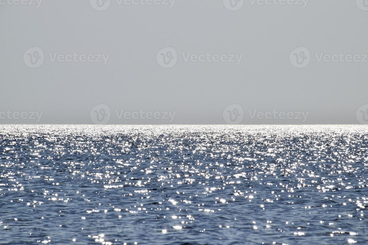 Sea line of the horizon. Sea and sky. The waves and glare of the sun are reflected from the waves of the sea. Seascape. photo