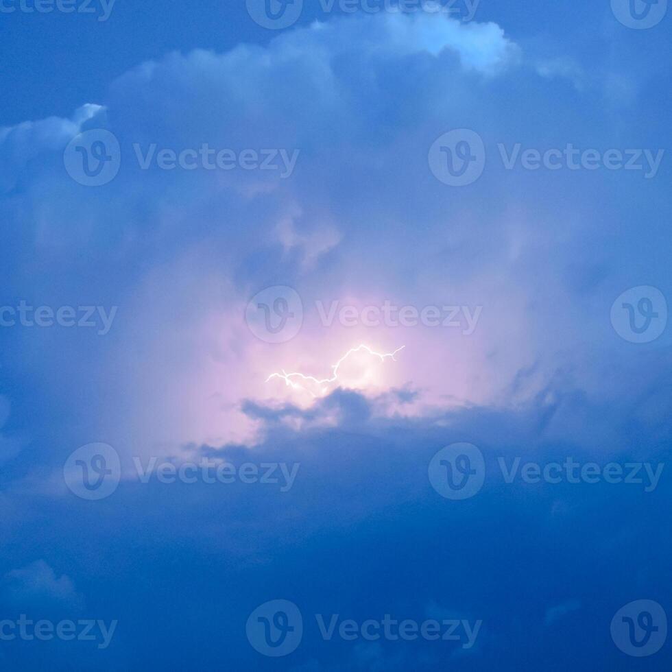 Lightnings in storm clouds. Peals of a thunder and the sparkling lightnings in clouds photo