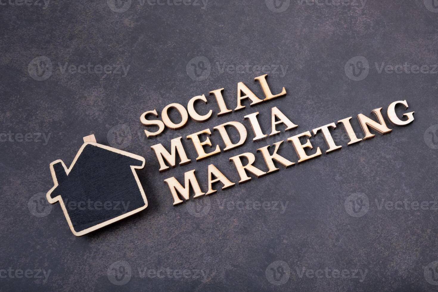 Social Media Marketing inscription made with wooden letters, top view on dark background. photo