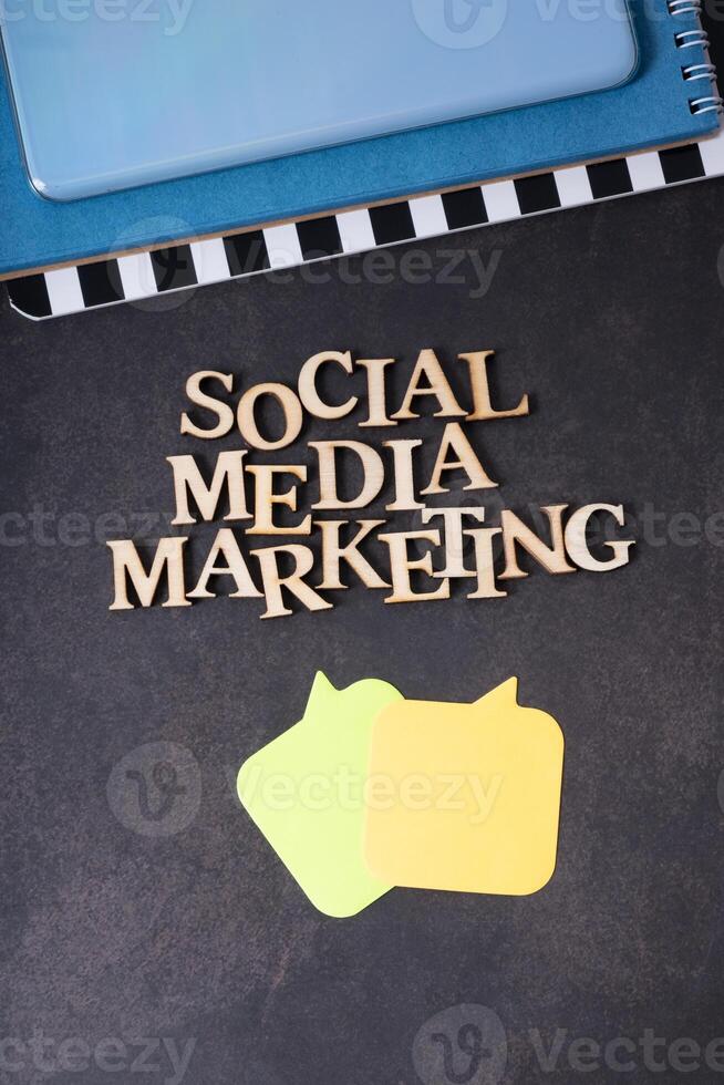 Social Media Marketing inscription made with wooden letters, top view on dark background. photo