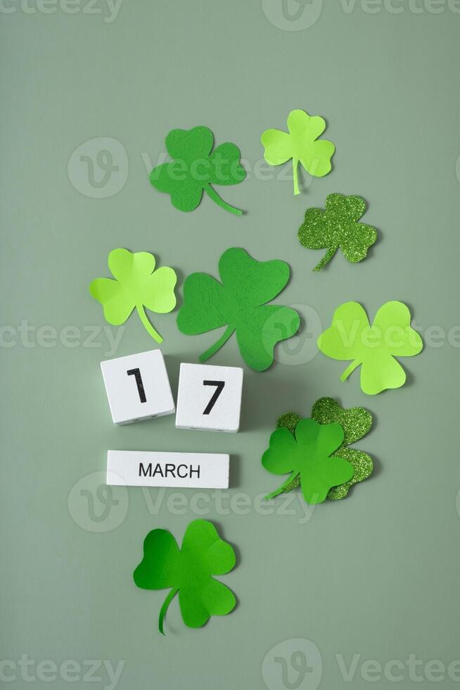 March 17 calendar and green clover leaves top view. St. Patrick's Day concept photo