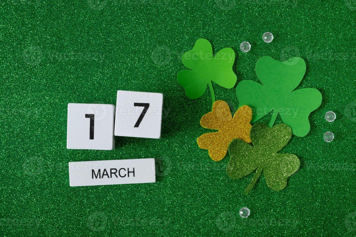 March 17 calendar and green clover leaves top view. St. Patrick's Day concept photo