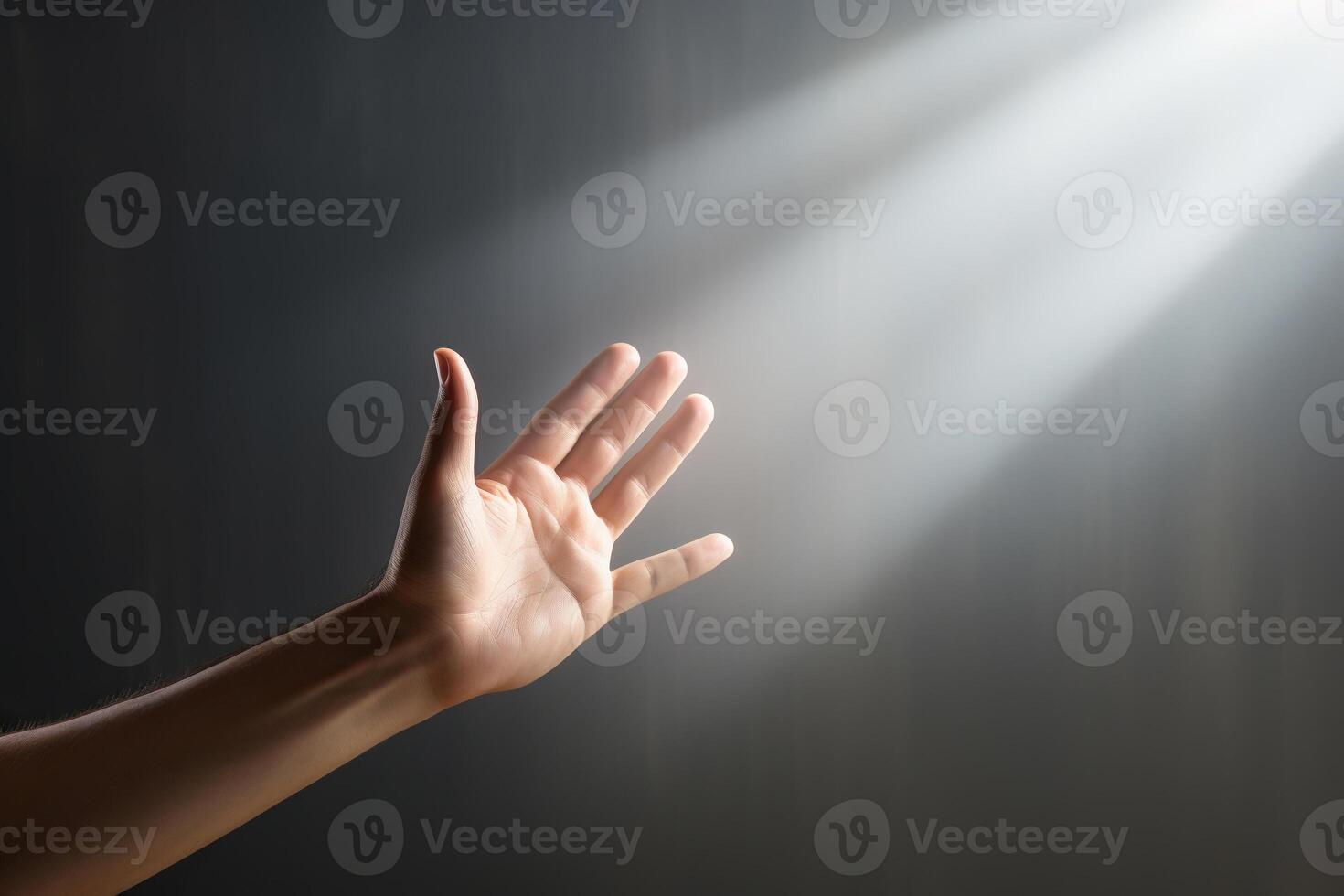 AI generated A man's hand reaches out to the rays of light against the background of a gray wall. Concept of spiritual life, support. Generated by artificial intelligence photo