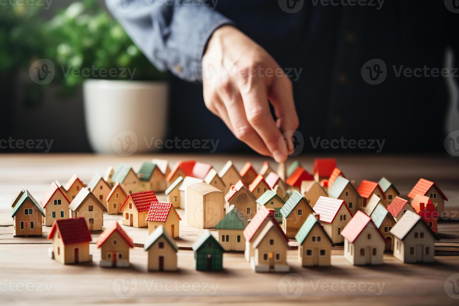 AI generated A man's hand over wooden house models. The concept of searching, buying a home. Generated by artificial intelligence photo