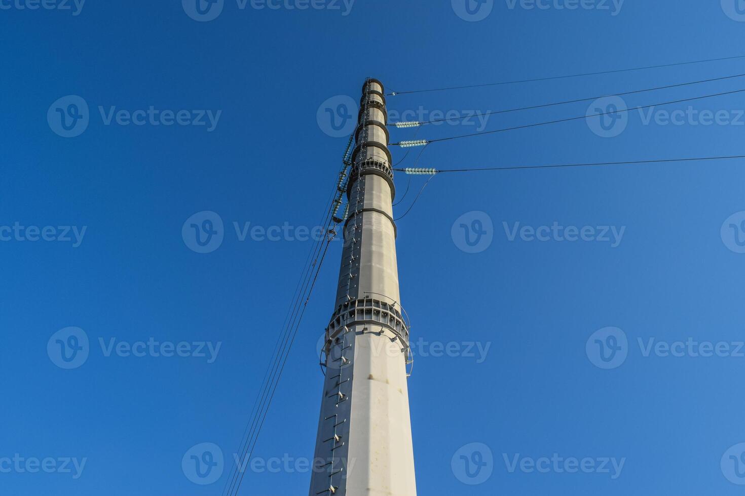Supports high-voltage power lines against the blue sky photo