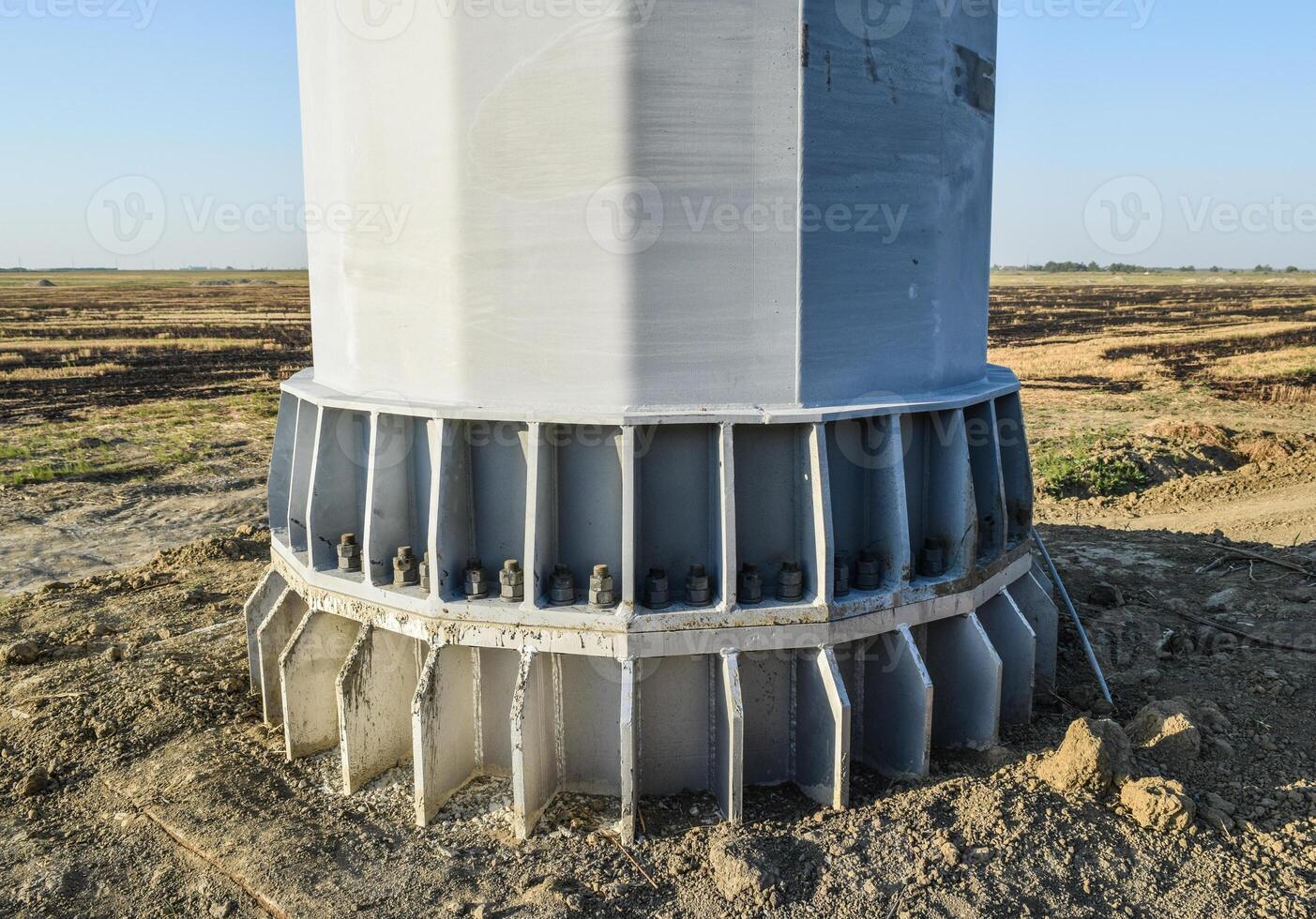 The base of the column power line support. Massive metal pole photo