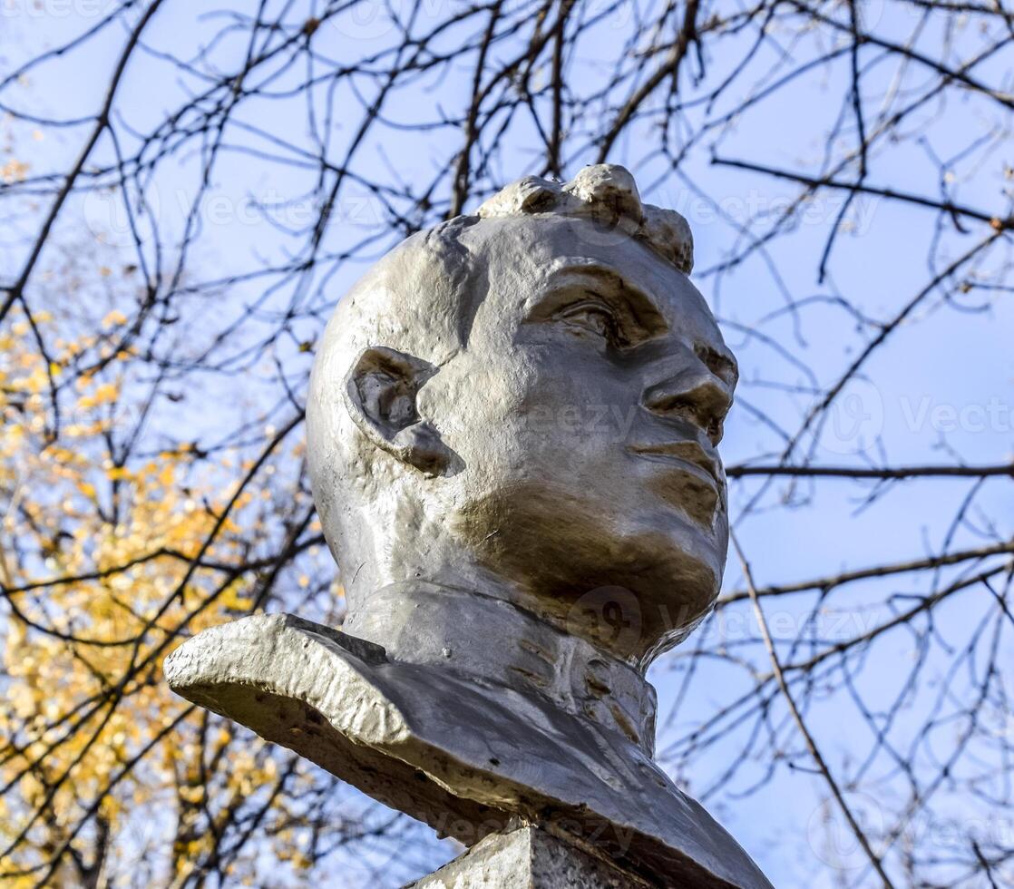 The face of the stone man. Concrete soldier bust covered with pa photo