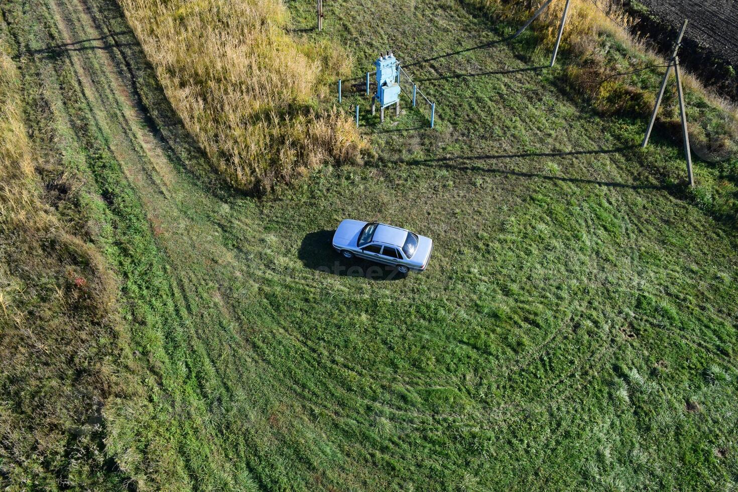 Top view of a silver car standing on the lawn. One Flew Over the Car. photo