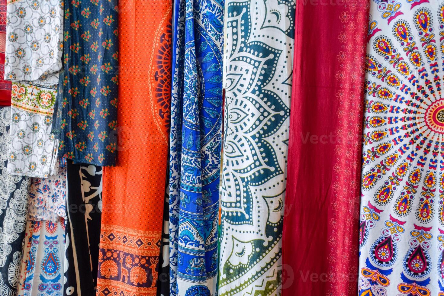 Indian fabrics hanging on the counter. Trade in fabrics from india. Fabric with patterns and patterns photo
