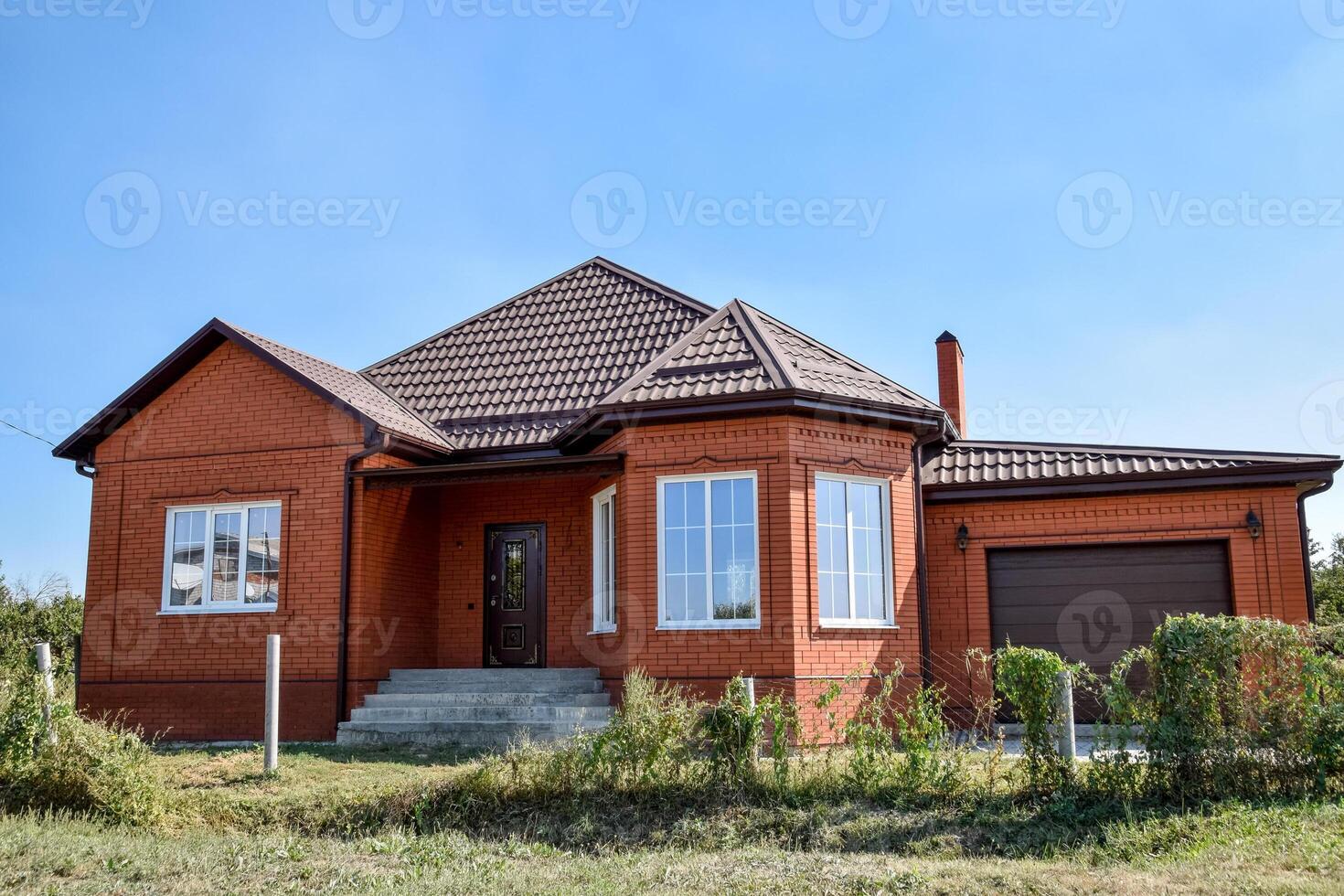 Detached house with a roof made of steel sheets. photo