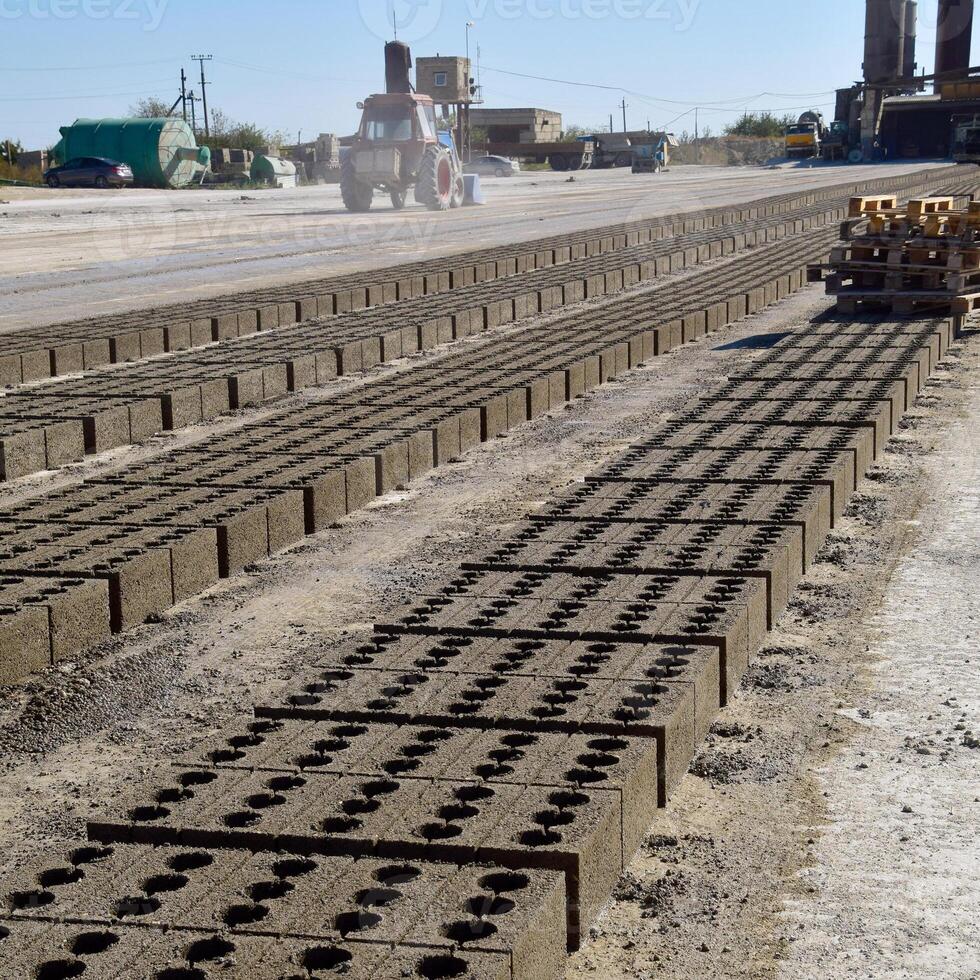 Cinder blocks lie on the ground and dried. on cinder block production plant. photo