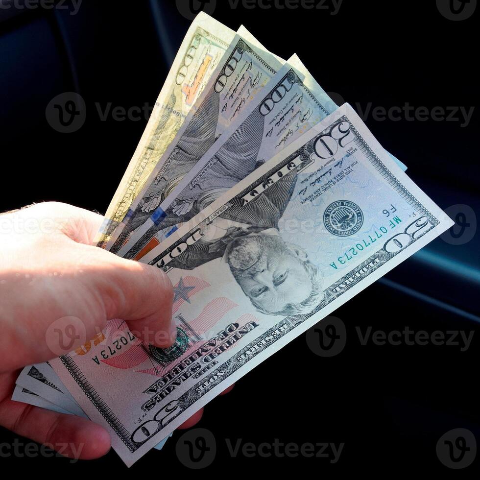 Hand transmitter dollars. Transferring money out of the hands. American dollars in a hand photo