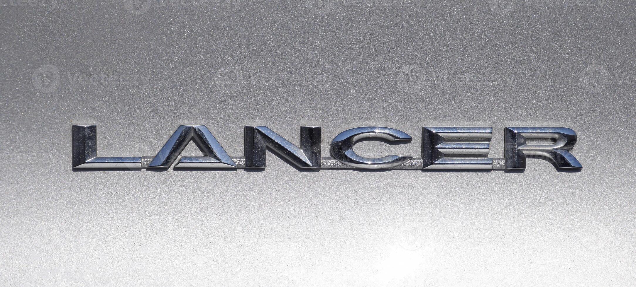 Lancer inscription on a silver background. Relief letters photo