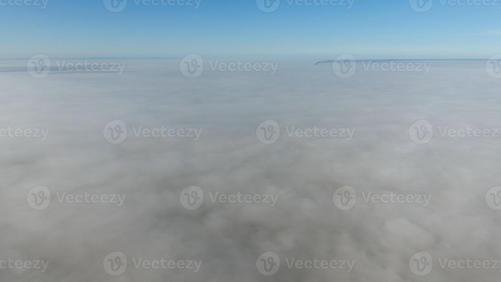 Fog above the ground. Top view of the fog. Low clouds. Morning mist condensation. Shooting with a drone photo