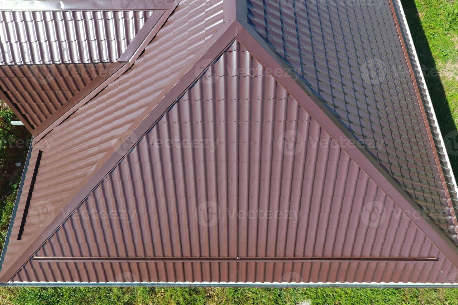 A view from above on the roof of the house. The roof of corrugated sheet. Roofing of metal profile wavy shape photo