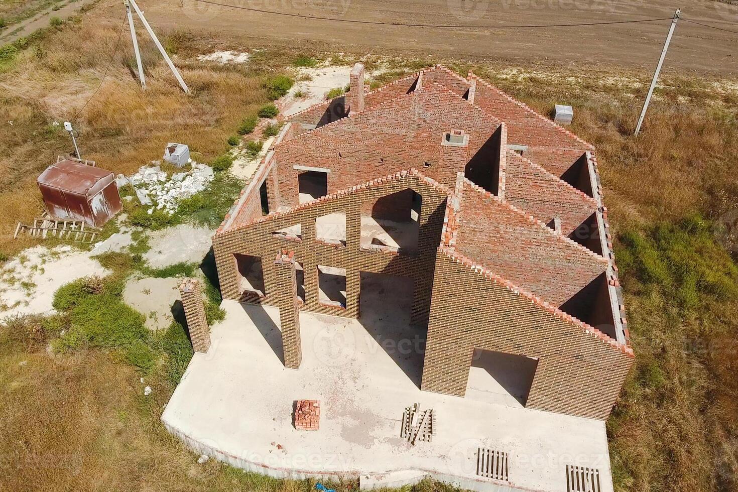 The house is built of red brick. The walls of the house are a to photo