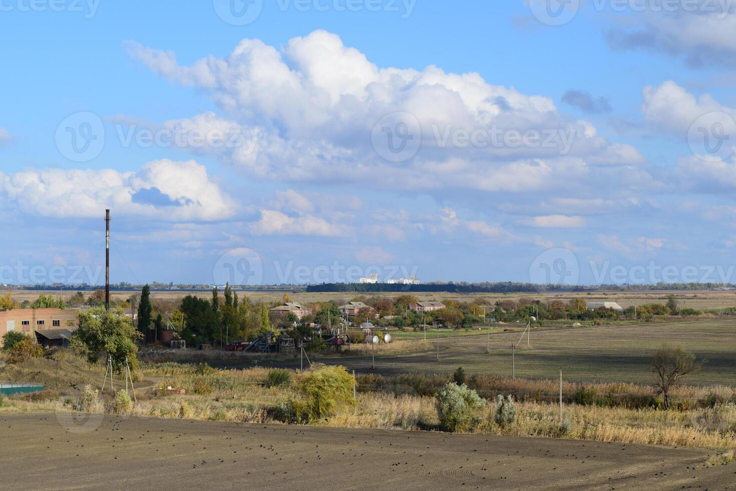 A view from above of a small Russian village. Rural landscape. Field and village. A semi-abandoned village. photo