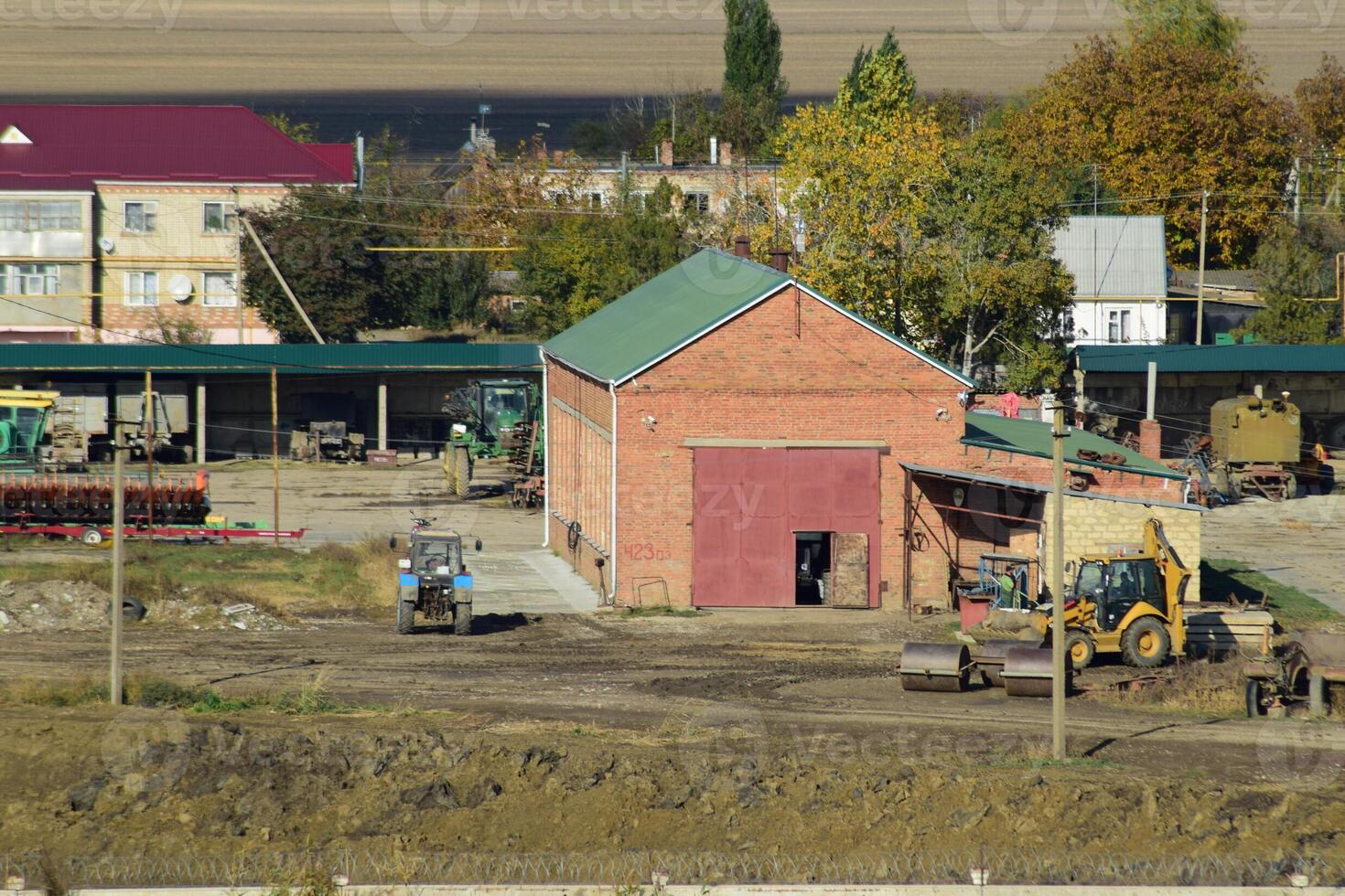 View of the farm garage. Parking of agricultural machinery. photo